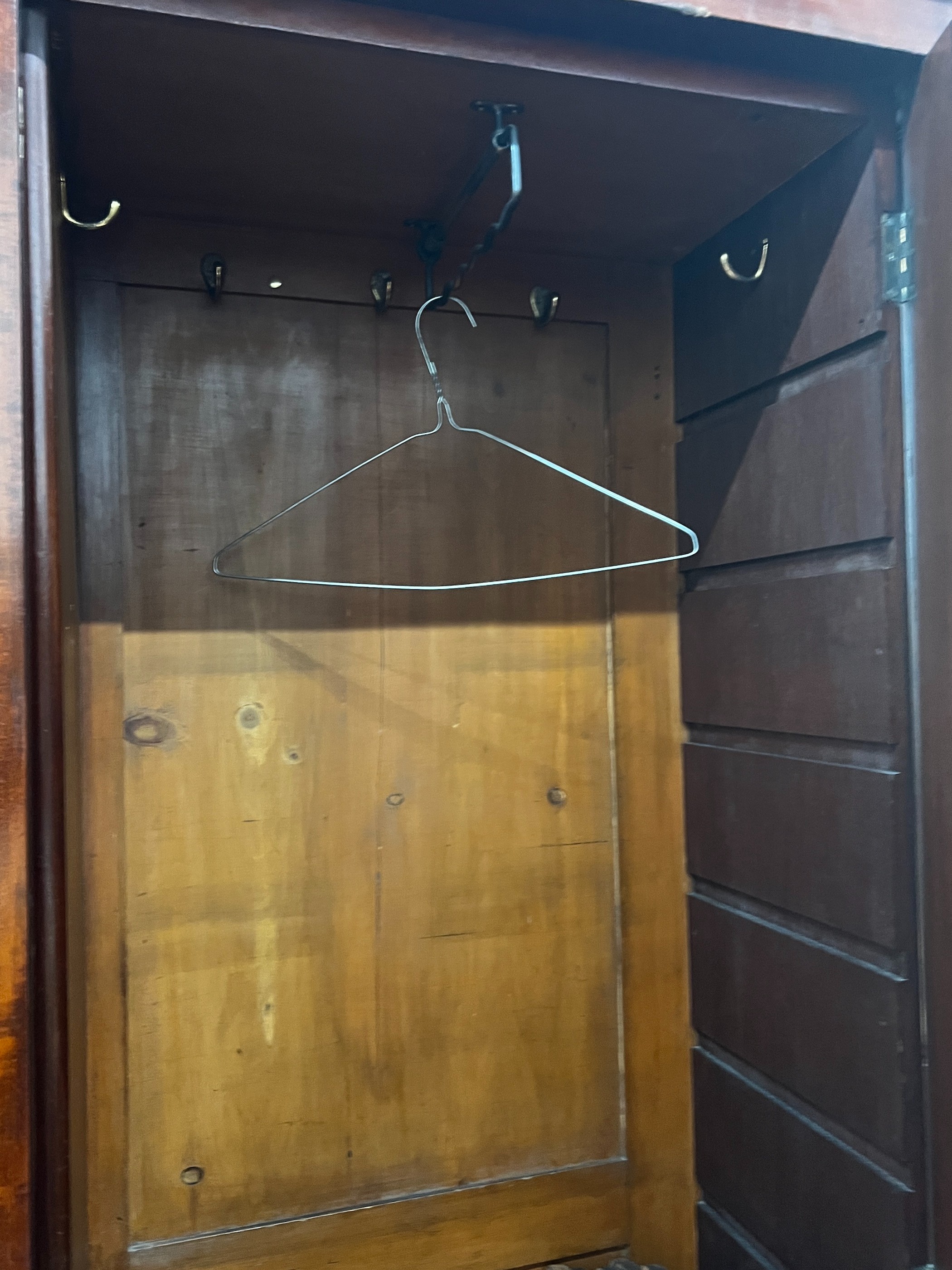 An early 20th century George III style panelled mahogany wardrobe, length 132cm, depth 42cm, height 210cm